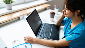spouse at desk with laptop